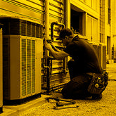 Technician working on an air conditioning unit