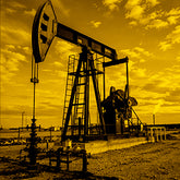 Oil pumpjack against the sky with clouds