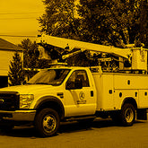 Utility truck with crane attachment in a residential area